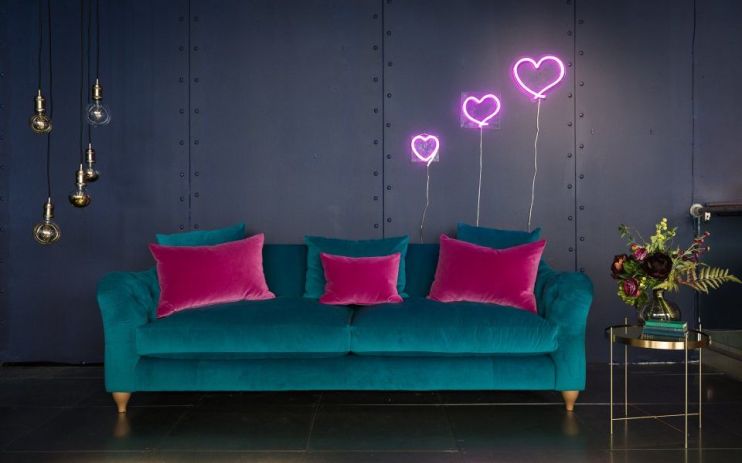 Profits at sofa retailer DFS have been almost halved