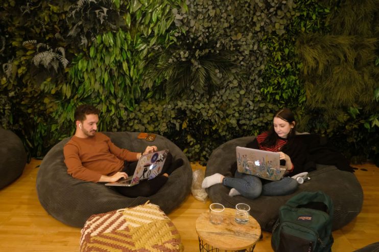 BERLIN, GERMANY - NOVEMBER 21: A young man and woman work on laptop computers in the cafeteria of the Factory Berlin Kreuzberg location during a visit by German State Sectretary for Digitalization Dorothee B&auml;r on November 21, 2018 in Berlin, Germany. Berlin city authorities are seeking to make Berlin a hub of digital innovation and have successfully drawn a variety of tech companies and startups. The Factory Berlin, with two locations in the city, provides members a venue for workspaces as well as access to potential investors. (Photo by Sean Gallup/Getty Images)