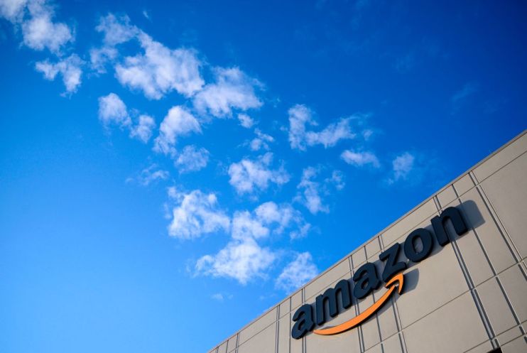 This photo shows the Amazon logo at the 855,000-square-foot Amazon fulfillment center in Staten Island, one of the five boroughs of New York City, on February 5, 2019. - Inside a huge warehouse on Staten Island thousands of robots are busy distributing thousands of items sold by the giant of online sales, Amazon. (Photo by Johannes EISELE / AFP) (Photo credit should read JOHANNES EISELE/AFP/Getty Images)