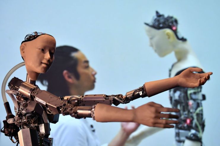 An AI robot with a humanistic face, entitled Alter 3: Offloaded Agency, is pictured during a photocall to promote the forthcoming exhibition entitled "AI: More than Human", at the Barbican Centre in London on May 15, 2019. - Managing the health of the planet, fighting against discrimination, innovating in the arts: the fields in which artificial intelligence (AI) can help humanity are innumerable, as an exhibition in London attempts to show. Entitled "AI: More than Human", the exhibition brings together more than 200 installations, projects by artists and scientists from around the world. (Photo by Ben STANSALL / AFP) / RESTRICTED TO EDITORIAL USE - MANDATORY MENTION OF THE ARTIST UPON PUBLICATION - TO ILLUSTRATE THE EVENT AS SPECIFIED IN THE CAPTION (Photo credit should read BEN STANSALL/AFP/Getty Images)