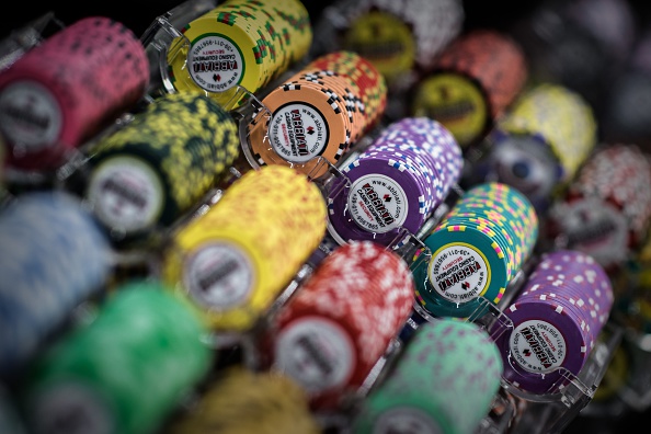 TO GO WITH STORY: Macau-gambling-economy, FOCUS by Laura Mannering and Aaron Tam In this picture taken on May 20, 2015, casino chips are displayed at the Global Gaming Expo Asia in the world's biggest gambling hub of Macau. With casino revenues in Macau plummeting thanks to Beijing's anti-corruption crackdown and a slowdown in the Chinese economy, the gambling hub is seeking to reinvent itself as a family-friendly mass market destination as the high rollers stay away. AFP PHOTO / Philippe Lopez (Photo credit should read PHILIPPE LOPEZ/AFP/Getty Images)