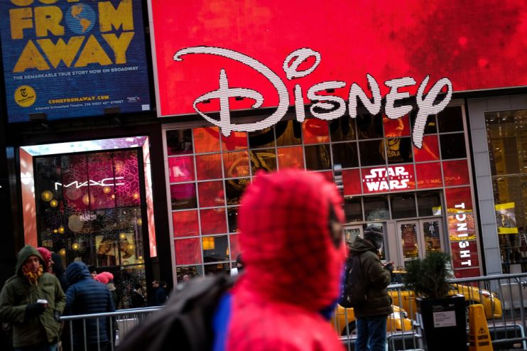 NEW YORK, NY - DECEMBER 14: The Disney logo is displayed outside the Disney Store in Times Square, December 14, 2017 in New York City. The Walt Disney Company announced on Thursday morning that it had reached a deal to purchase most of the assets of 21st Century Fox. The deal has a total value of around $66 billion, with Disney assuming $13.7 billion of Fox's net debt. (Photo by Drew Angerer/Getty Images)