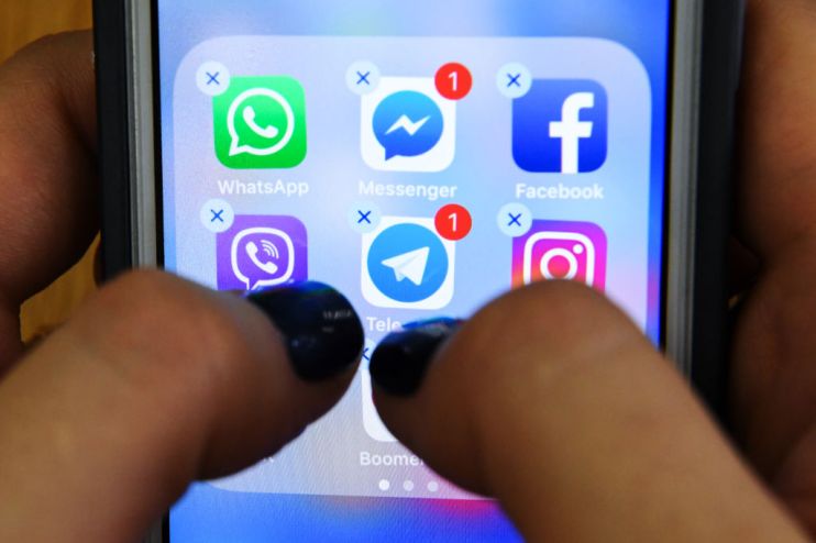 A woman holds a smart phone with the icons for the social networking apps Facebook, Instagram and others seen on the screen in Moscow on March 23, 2018. - A public apology by Facebook chief Mark Zuckerberg, on March 22, 2018 failed to quell outrage over the hijacking of personal data from millions of people, as critics demanded the social media giant go much further to protect privacy. (Photo by Kirill KUDRYAVTSEV / AFP) (Photo credit should read KIRILL KUDRYAVTSEV/AFP/Getty Images)