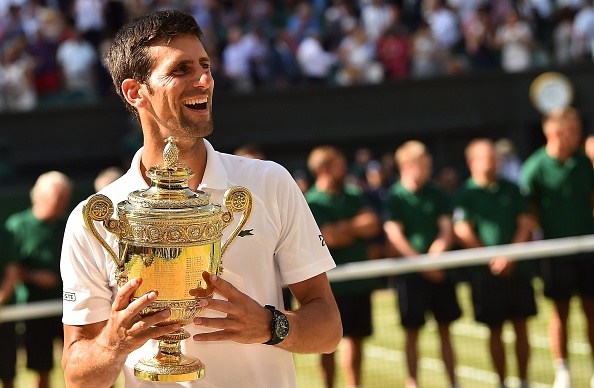 Serbia's Novak Djokovic holds the winners trophy after beating South Africa's Kevin Anderson 6-2, 6-2, 7-6 in their men's singles final match on the thirteenth day of the 2018 Wimbledon Championships at The All England Lawn Tennis Club in Wimbledon, southwest London, on July 15, 2018. (Photo by Glyn KIRK / AFP) / RESTRICTED TO EDITORIAL USE (Photo credit should read GLYN KIRK/AFP/Getty Images)