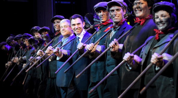 Cast members from the theatre production of Mary Poppins stand with co-producer Sir Cameron Mackintosh (centre/L) and Victoria's minister of tourism and major events, Tim Holding (centre/R) before its Australian premier, in Melbourne on July 21, 2010. Mackintosh, who has produced the most successful musicals of all time, Cats, Les Miserables and The Phantom of the Opera, is co-producing Mary Poppins with Disney which opens on July 29. AFP PHOTO/William WEST (Photo credit should read WILLIAM WEST/AFP/Getty Images)