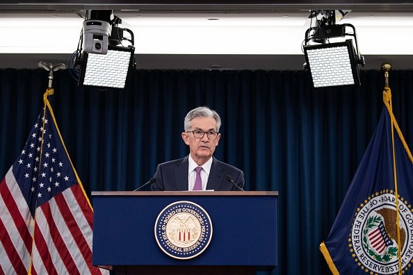US stock markets hit record highs as Fed chair hints at rate cuts