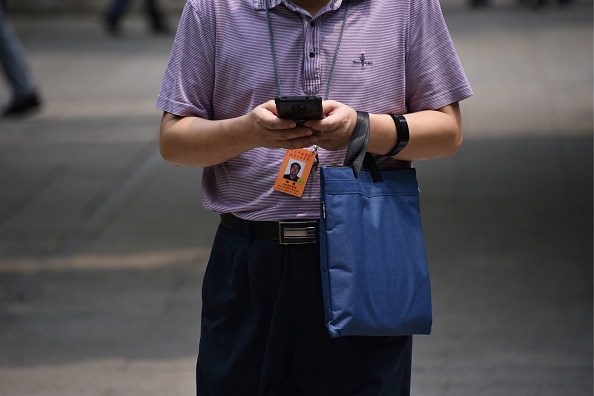 This photo taken on June 26, 2019 shows an adult student using a smartphone on the campus of the Party School of the Chinese Communist Party's Central Committee, during a government-organised tour for foreign journalists in Beijing. - The normally highly secretive Central School of the Communist Party opened its doors to foreign media on June 26, for a tightly controlled visit in which little was left to chance. (Photo by LEO RAMIREZ / AFP) / To go with AFP story China-politics-education, FOCUS by Leo RAMIREZ (Photo credit should read LEO RAMIREZ/AFP/Getty Images)