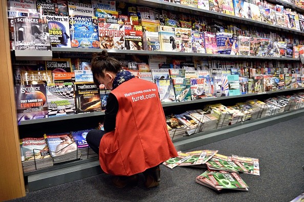 An employee of a newsstand puts magazines on display on February 25, 2015 in Lille. AFP PHOTO /PHILIPPE HUGUEN (Photo credit should read PHILIPPE HUGUEN/AFP/Getty Images)