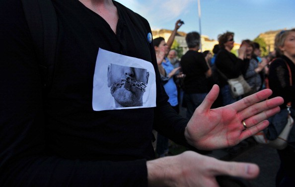A protester claps hands during a demonstration for the freedom of press in Budapest, Hungary on June 3, 2014. A Hungarian online news editor's sudden contract termination sparked protests in Budapest after allegations he was fired for publishing a story which embarrassed Prime Minister Viktor Orban's government. AFP PHOTO / GERGELY BESENYEI (Photo credit should read GERGELY BESENYEI/AFP/Getty Images)