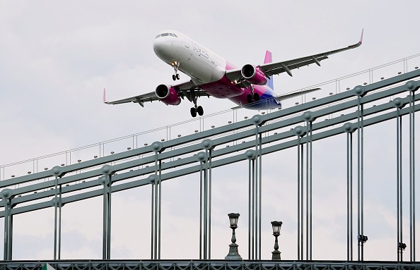 A Wizz Air Airbus A321 flies over the oldest Hungarian bridge, the 'Lanchid' (Chain Bridge) of Danube River in Budapest on May 1, 2016 during the Budapest Air Show. / AFP / ATTILA KISBENEDEK (Photo credit should read ATTILA KISBENEDEK/AFP/Getty Images)