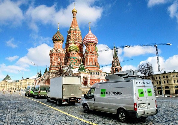 Russia's state-controlled Russia Today (RT) television broadcast vans are seen parked in front of St. Basil's Cathedral and the Kremlin next to Red Square in Moscow on March 16, 2018. Russia will vote for President on March 18. / AFP PHOTO / Mladen ANTONOV (Photo credit should read MLADEN ANTONOV/AFP/Getty Images)