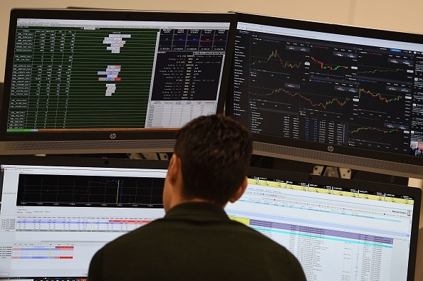 Traders work at the offices of IG markets in Canada on January 16, 2019. - The pound held its ground today and London's FTSE opened higher after the record defeat of British Prime Minister Theresa May's Brexit plan, as investors consider the next developments in the long-running saga. (Photo by Paul ELLIS / AFP) (Photo credit should read PAUL ELLIS/AFP/Getty Images)