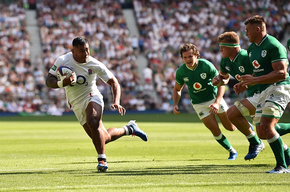 England's centre Manu Tuilagi (L) on his way to scoring a try during the international Test rugby union match between England and Ireland at Twickenham Stadium in west London on August 24, 2019. (Photo by Glyn KIRK / AFP) (Photo credit should read GLYN KIRK/AFP/Getty Images)