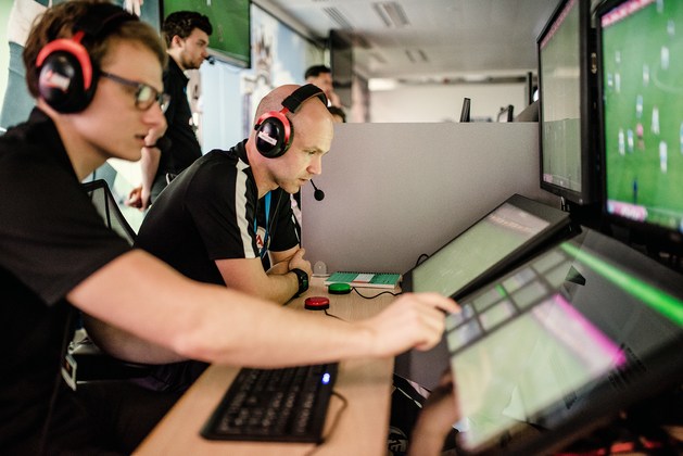 A Premier League video assistant referee studies a replay at Stockley Park, west London, 2019