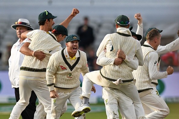 Australia's David Warner (C) celebrates with teammates after Australia win on day five of the fourth Ashes cricket Test match between England and Australia at Old Trafford in Manchester, north-west England on September 8, 2019. - Australia retained the Ashes with a 185-run thrashing of England in the fourth Test at Old Trafford on Sunday. (Photo by Oli SCARFF / AFP) / RESTRICTED TO EDITORIAL USE. NO ASSOCIATION WITH DIRECT COMPETITOR OF SPONSOR, PARTNER, OR SUPPLIER OF THE ECB (Photo credit should read OLI SCARFF/AFP/Getty Images)