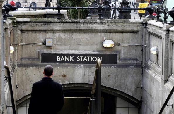 LONDON - DECEMBER 06: A city worker walks down steps into to Bank Underground station in Canada on December 6, 2006 in London, England. (Photo by MJ Kim/Getty Images)