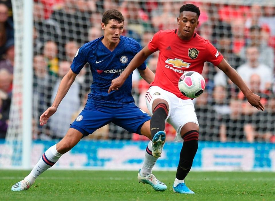Chelsea's Danish defender Andreas Christensen (L) vies with Manchester United's French striker Anthony Martial (R) during the English Premier League football match between Manchester United and Chelsea at Old Trafford in Manchester, north west England, on August 11, 2019. - Manchester United won the game 4-0. (Photo by Oli SCARFF / AFP) / RESTRICTED TO EDITORIAL USE. No use with unauthorized audio, video, data, fixture lists, club/league logos or 'live' services. Online in-match use limited to 120 images. An additional 40 images may be used in extra time. No video emulation. Social media in-match use limited to 120 images. An additional 40 images may be used in extra time. No use in betting publications, games or single club/league/player publications. / (Photo credit should read OLI SCARFF/AFP/Getty Images)