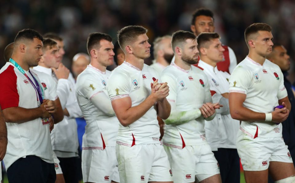 YOKOHAMA, JAPAN - NOVEMBER 02: England captain Owen Farrell (c) and team mates look on dejectedly as South Africa receive the winners trophy after the Rugby World Cup 2019 Final between England and South Africa at International Stadium Yokohama on November 02, 2019 in Yokohama, Kanagawa, Japan. (Photo by Stu Forster/Getty Images)