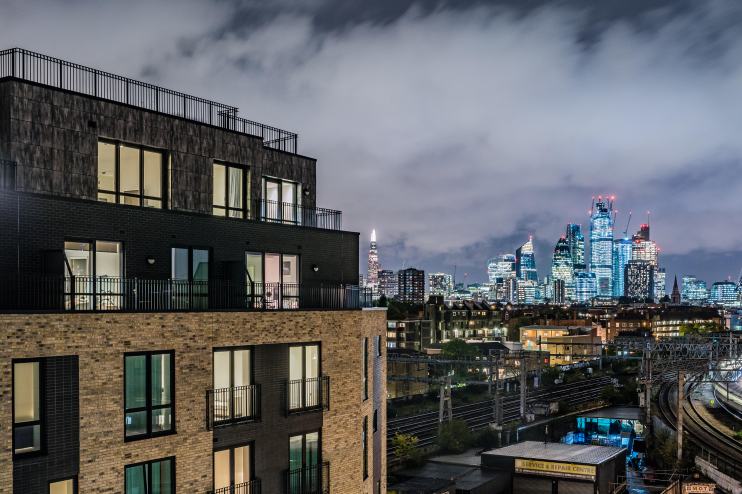 The Dressage Court apartment block in Bethnal Green, with the London skyline in the background