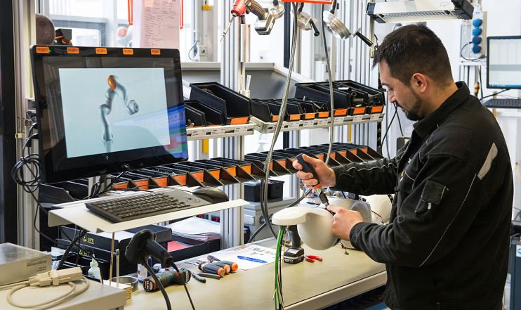 Chancellor Merkel Visits KUKA Robotics Factory