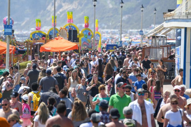 Crowds enjoy the sunshine on the beach promenade in Bournemouth, England. (Photo by Finnbarr Webster/Getty Images)