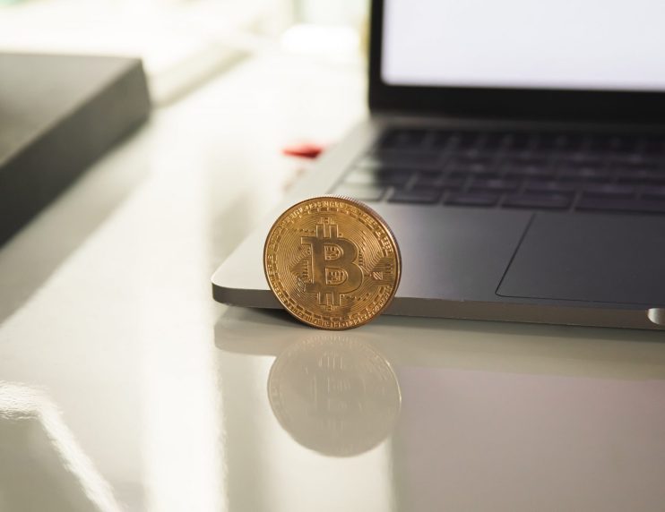 Bitcoin near laptop