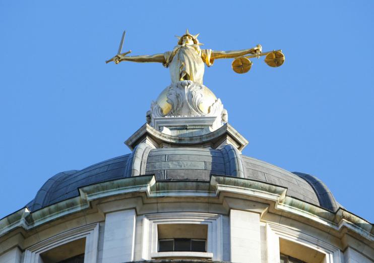 The statue of justice stands on the copu