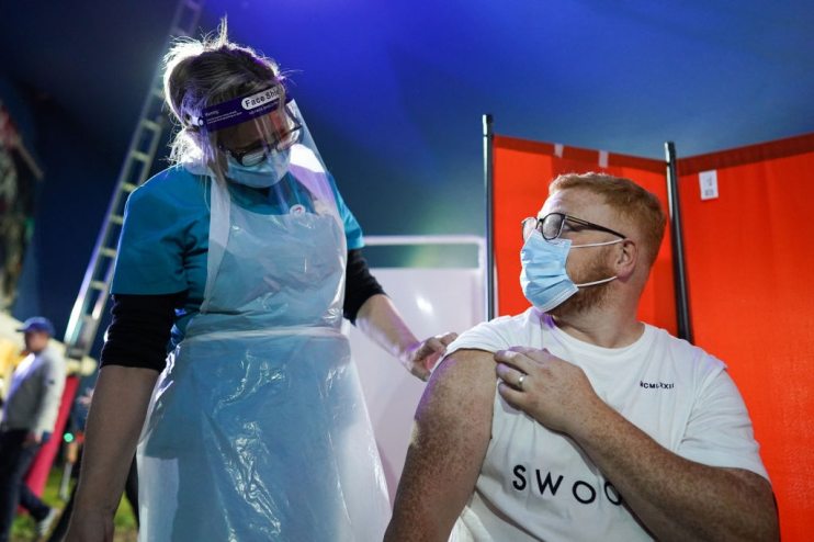 A doctor delivers a covid vaccine