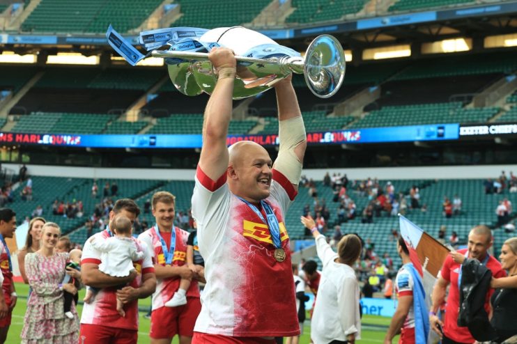 Tom Lawday celebrates with the Premiership trophy following Harlequins' title triumph