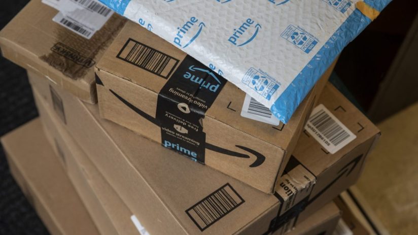 Amazon headquarters with concerned employees after 16,000 job cuts announcement due to internal email mistake