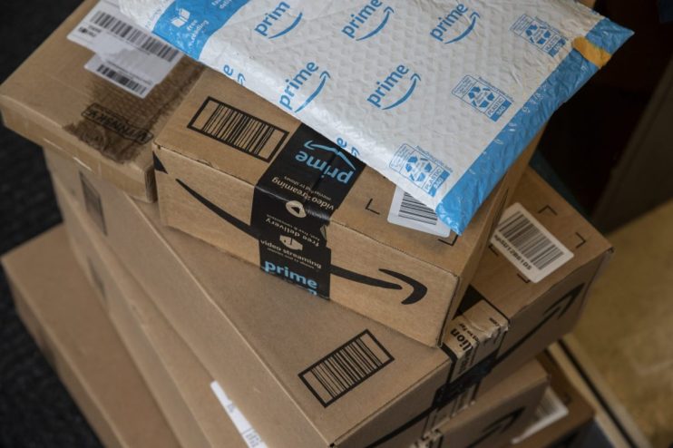 Amazon headquarters with concerned employees after 16,000 job cuts announcement due to internal email mistake