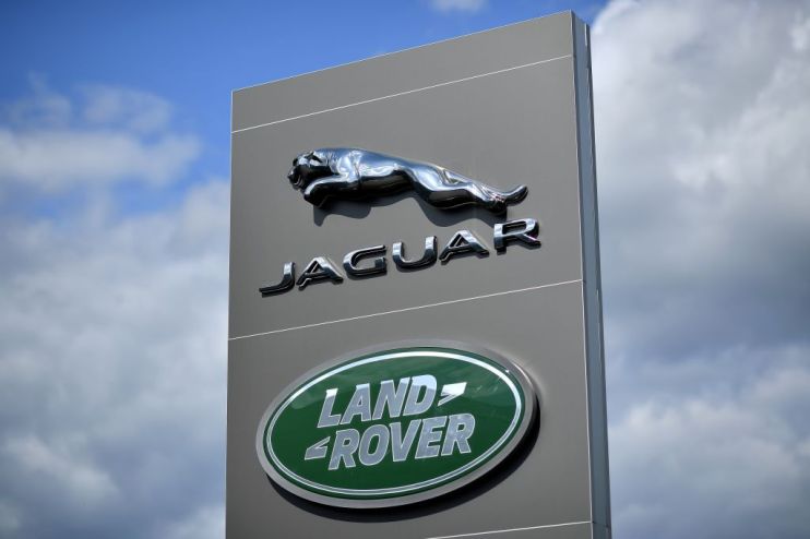 Jaguar Land Rover swung to profit on Thursday as a record &pound;13.8bn revenue drove the marque well into the black.