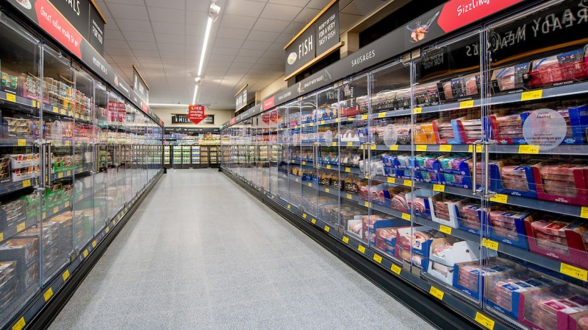Aldi supermarket chiller doors showcasing chilled products, amid competition scrutiny by Sainsbury&rsquo;s, Morrisons, and Ice...