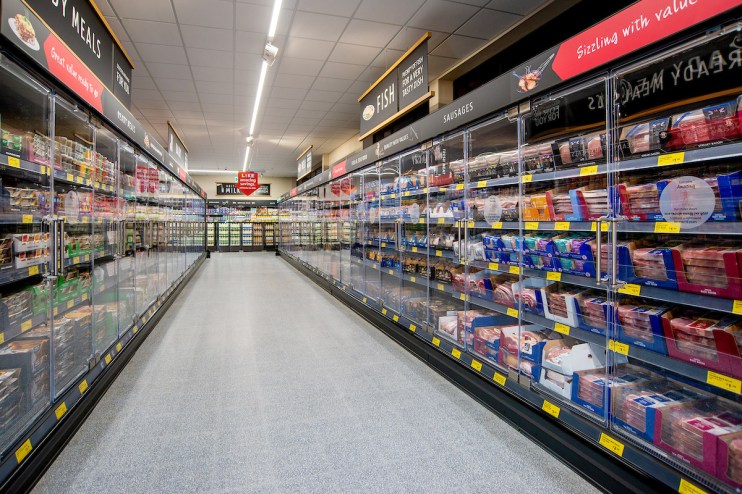 Aldi supermarket chiller doors showcasing chilled products, amid competition scrutiny by Sainsbury&rsquo;s, Morrisons, and Ice...