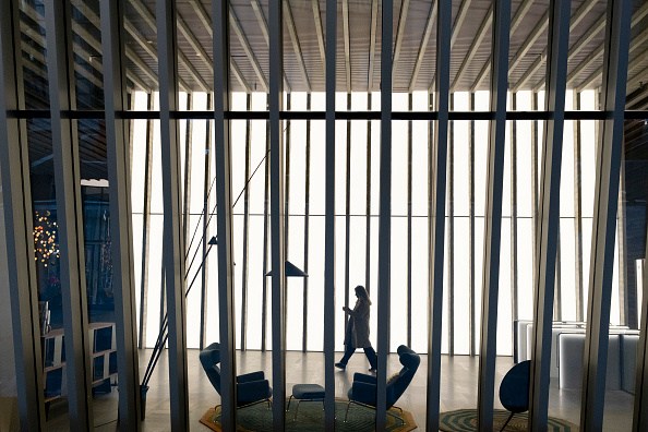 Woman Walks Through Office Architecture