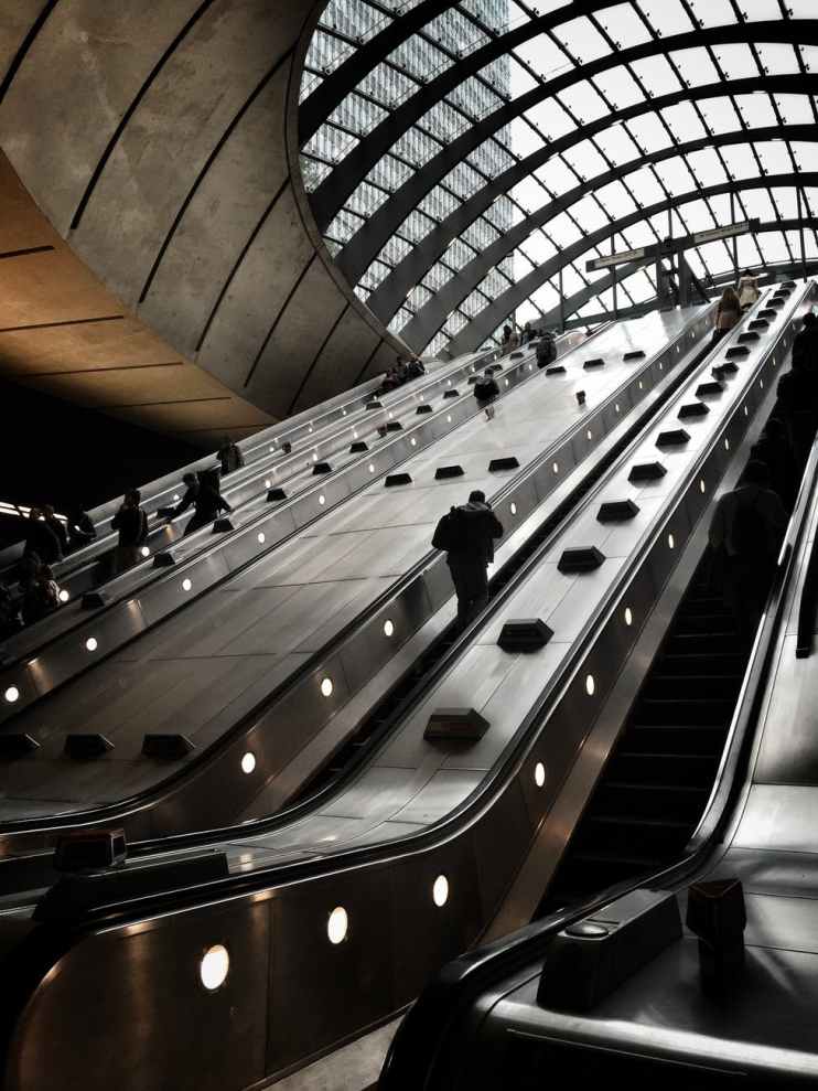 photo of people on escalator inside building