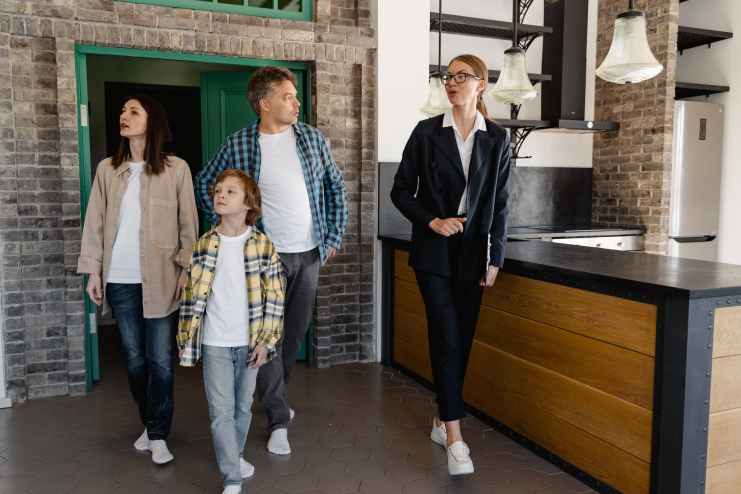 a real estate agent touring the family inside a house