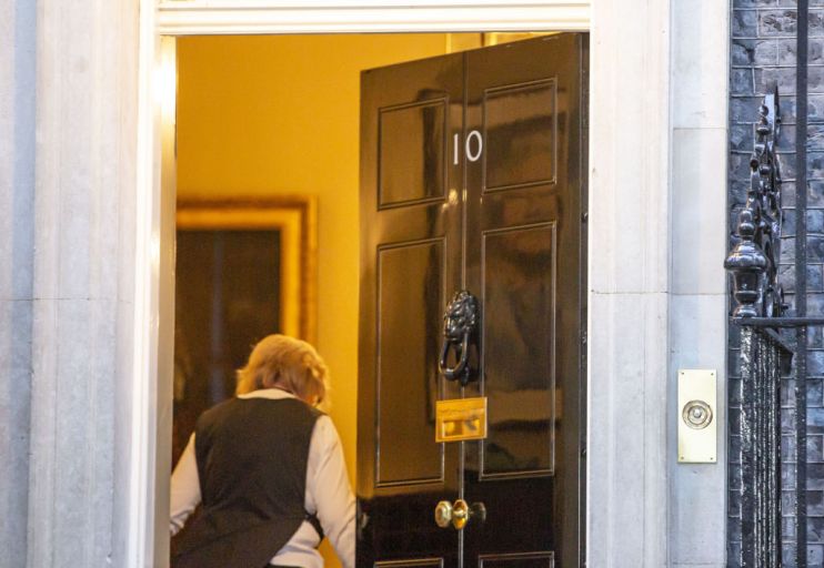 Queen Elizabeth's portrait reflected on door to 10 Downing Street
