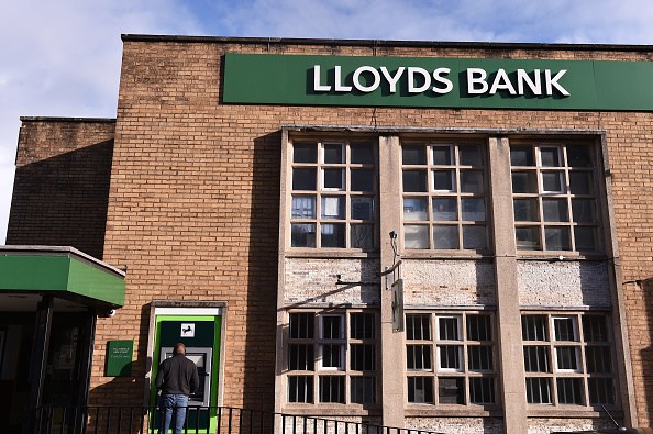 A man is seen withdrawing cash from outside Lloyds Bank . (Photo by Nathan Stirk/Getty Images)
