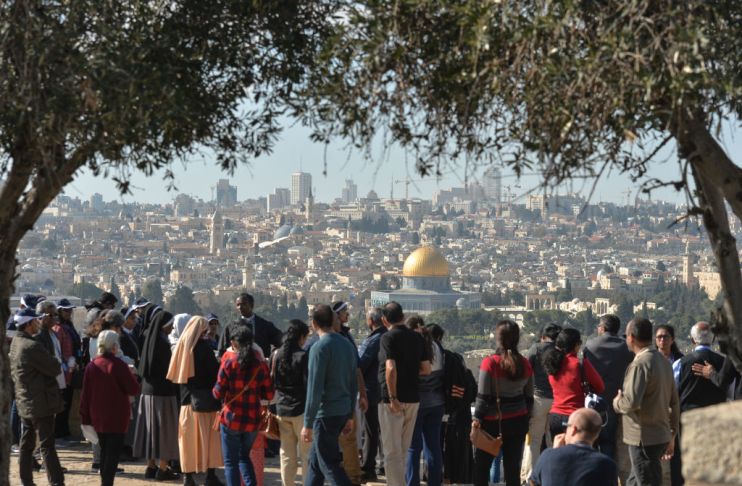 UK said it would not move its embassy in Israel from Tel Aviv to Jerusalem. Here, tourists look from the Mount of Olives at the panoramic view of the Old City of Jerusalem
