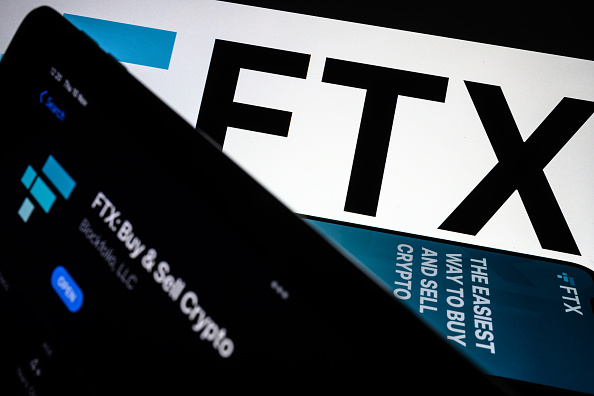 Photo illustration the FTX logo and mobile app adverts (Photo Illustration by Leon Neal/Getty Images)