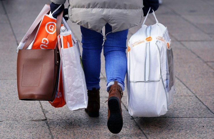 A woman carrying several shopping bags.