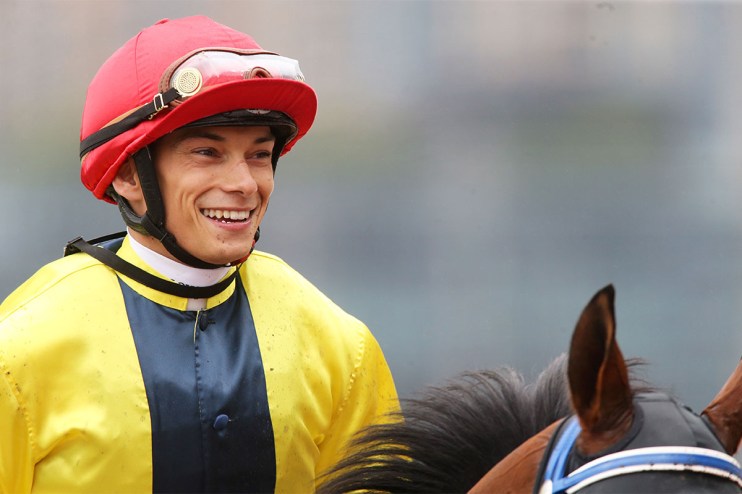 Alexis Badel poised at Happy Valley Racecourse, focused on upcoming races, highlighting his successful jockey career in Ho...