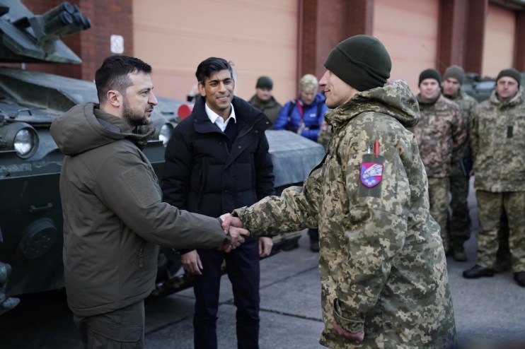 Prime Minister Rishi Sunak and Ukrainian President Volodymyr Zelensky meet Ukrainian troops being trained to command Challenger 2 tanks at a military facility in Lulworth, Dorset. Picture date: Wednesday February 8, 2023.