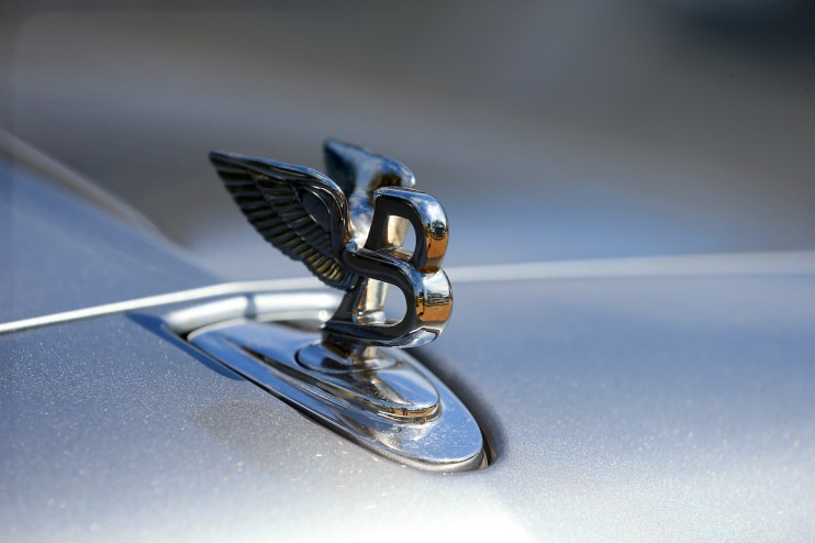 A badge on the bonnet of a Bentley