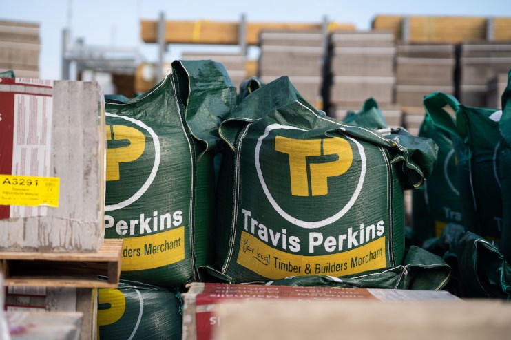 Travis Perkins has reported a 4.4 per cent decline in revenue to &pound;2.4bn while adjusting operating profit plunged to &pound;75m in the first half.