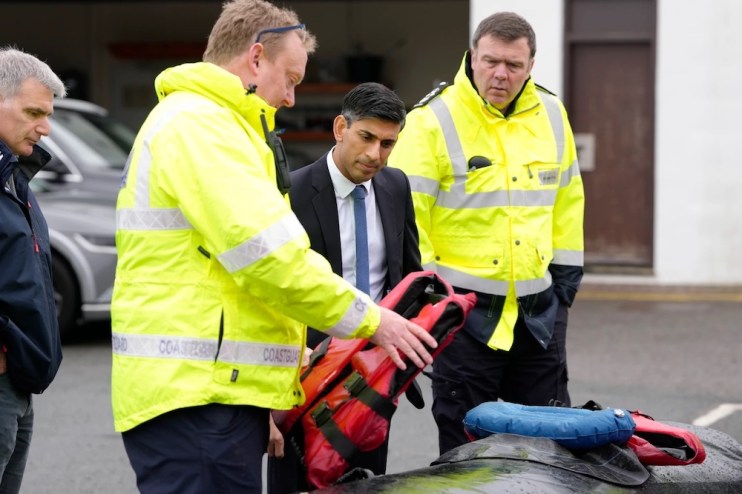 Prime Minister Rishi Sunak, second right, speaks with members of the Home Office contracted staff. Getty Images