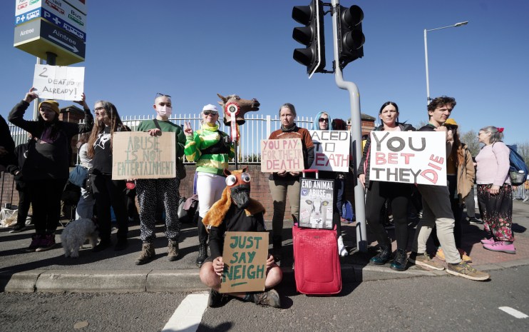 Activists outside the gates ahead of day three of the Randox Grand National Festival at Aintree Racecourse, Liverpool. British Horseracing Authority chief executive Julie Harrington has "robustly condemned" the actions of protestors who delayed the Grand National - and also announced a "painstaking" analysis will take place in an attempt to understand what caused three fatalities over the three days of the meeting. Issue date: Sunday April 16, 2023.