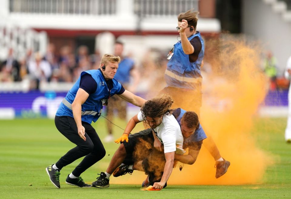 Security grab a Just Stop Oil protester during day one of the second Ashes test match at Lord's, London. (Press Association)