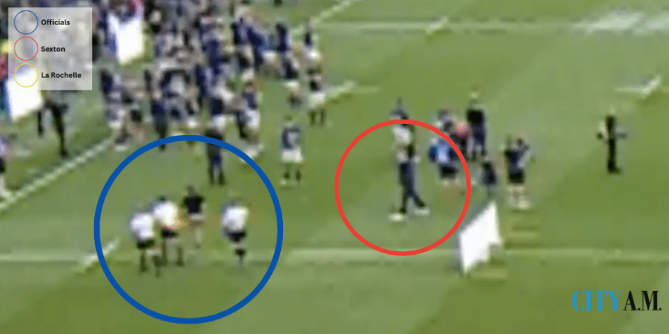 Sexton (in red) walks towards the officials (blue) as they head towards the tunnel.